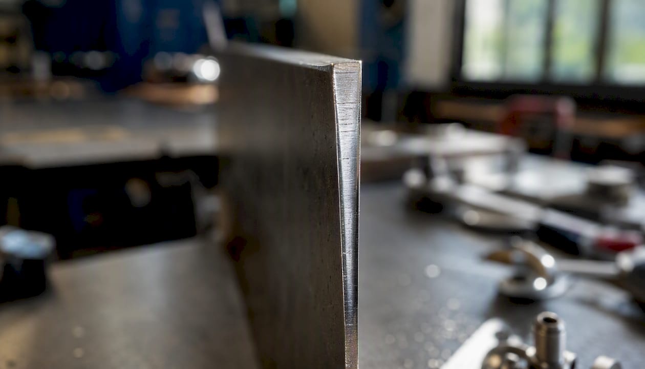 Side view of laser cut metal edge showing kerf taper