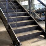Close-up of industrial metal stairs with handrail