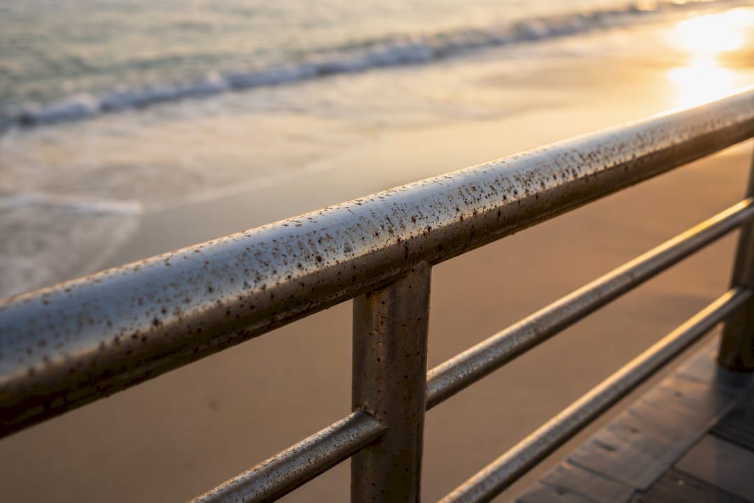 Corroded coastal stainless steel surface close-up