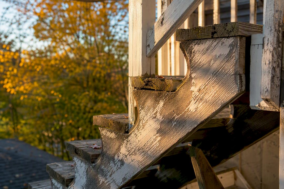 Weathered wooden stair stringer outdoor close-up