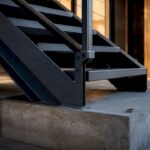 Cropped steel stair installation at renovation site