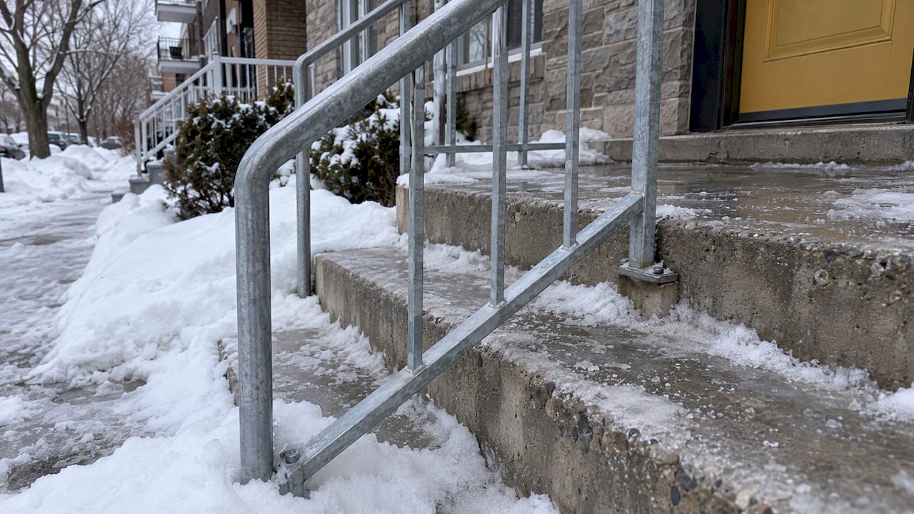 Snow and salt around exterior stair handrail