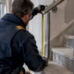 Fabricator measuring Montreal stair handrail height