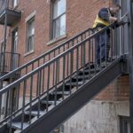 Installer fitting custom steel exterior staircase