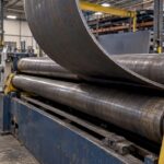 Steel plate curving through a rolling machine