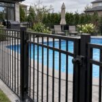 Metal fence enclosing a residential swimming pool