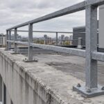 Steel guardrail posts anchored along a rooftop edge