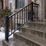 Steel railing beside wet Montreal duplex steps